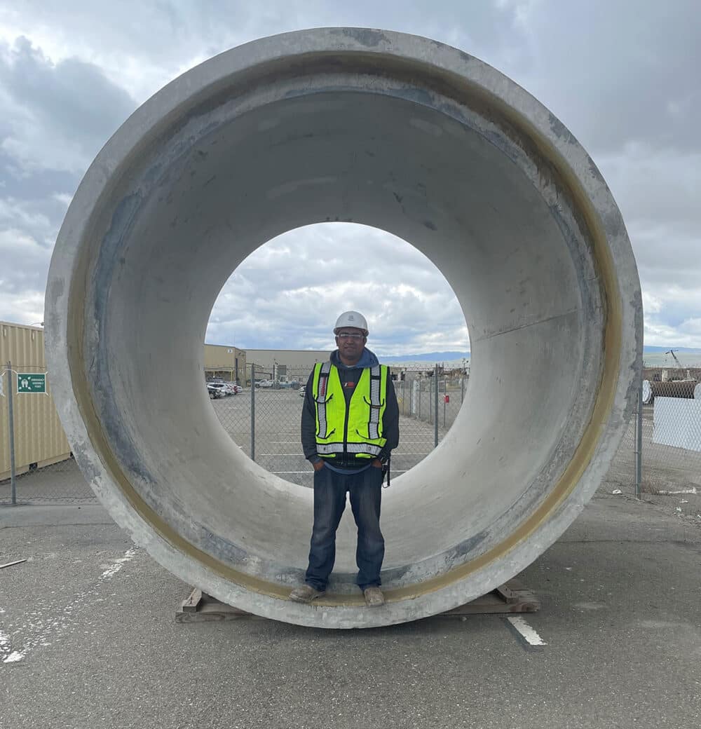 Horacio stands inside a large-diameter Verticast concrete pipe manufactured at the Tracy Plant